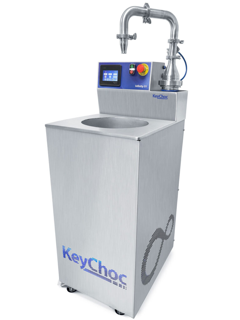 KeyChoc Infinity BX chocolate tempering machine, angled side view, with touchscreen control panel, emergency stop button, overhead dispensing spout, open top tank and castor wheels
